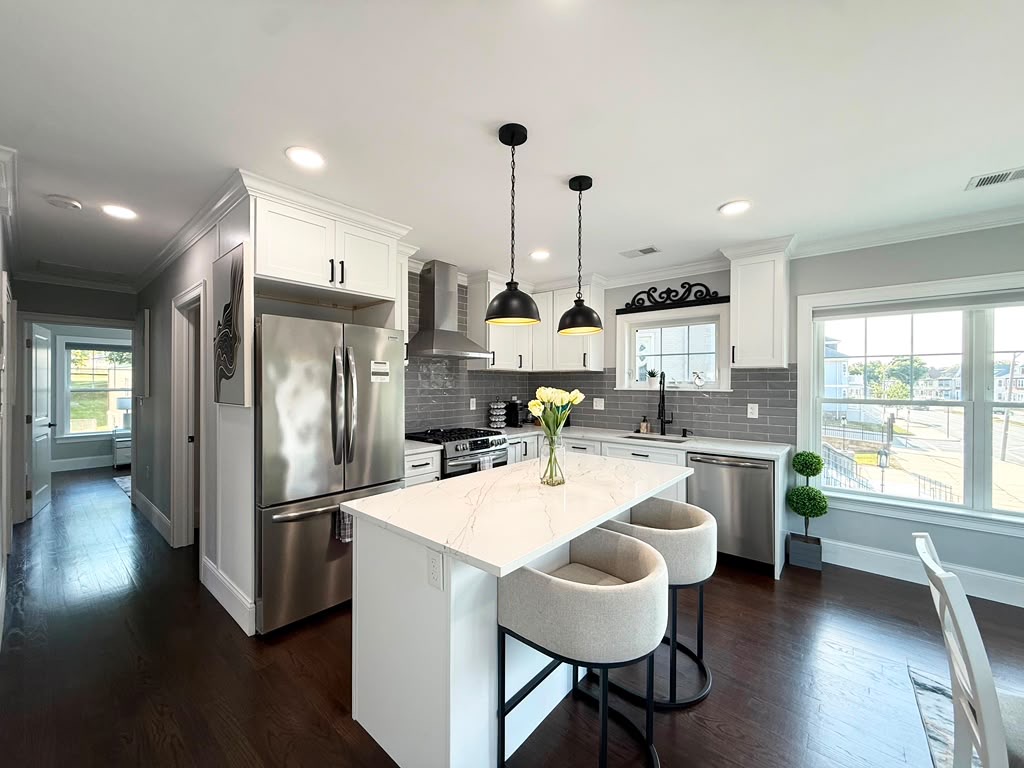 Bright, clean kitchen with white cabinets and a large center island